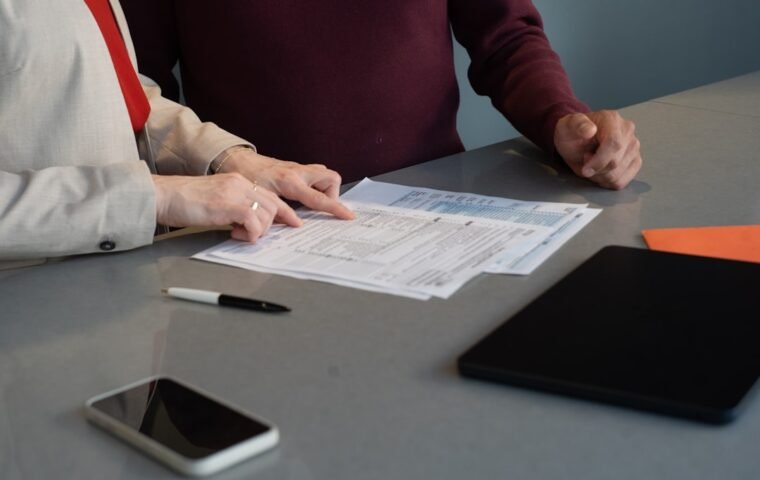 Business professionals reviewing procurement documents before submitting a tender
