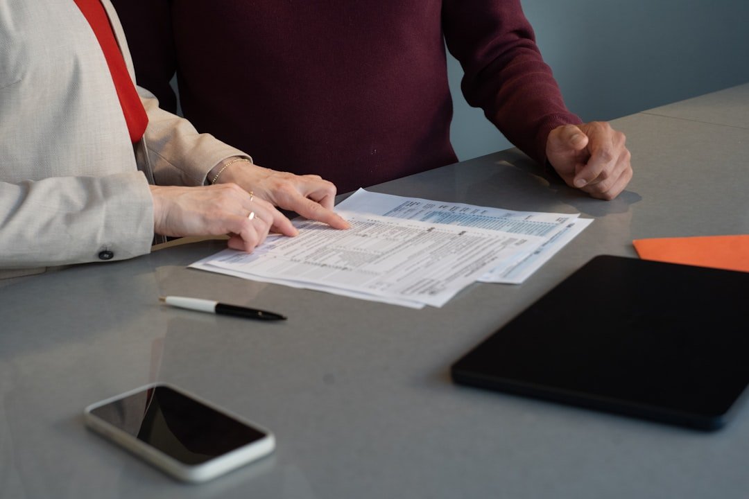 Business professionals reviewing procurement documents before submitting a tender
